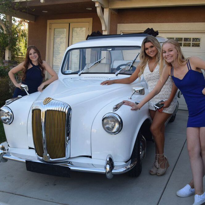 Young girl posing for picture with London Taxi cab.