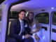 Bride and Groom sitting the back seat of London Taxi cab.