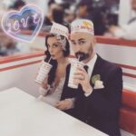 Goofy glamorous couple sipping shakes at In-N-Out
