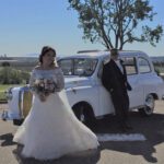 Couple posing in front of London taxi