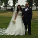 Newlyweds pose for picture outdoors