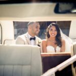 Newlyweds in back seat of Taxi car