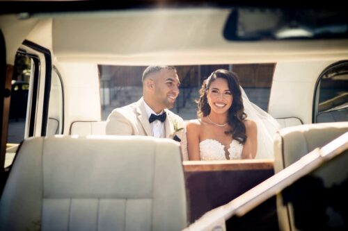 Newlyweds in back seat of Taxi car